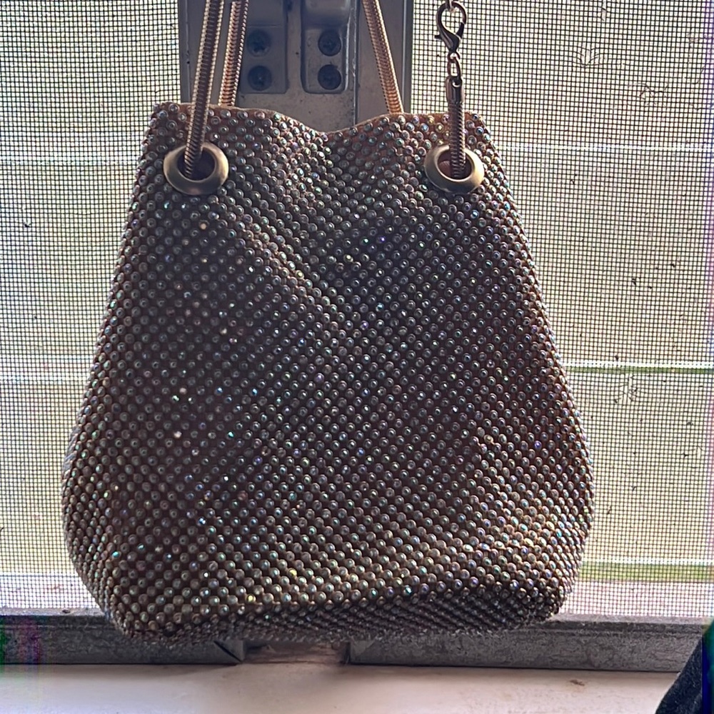 This is a gold beautiful bag and the strap can be taken off and clips together